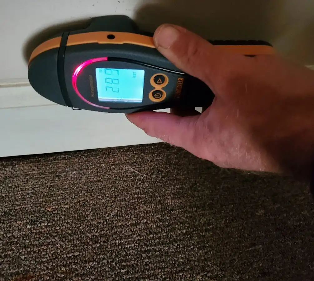 Moisture detection at baseboard during Storm Damage Restoration in Newtown
